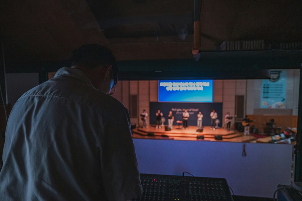 Sound technician at mixing board during a live church service